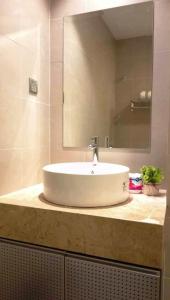 a bathroom with a white sink and a mirror at Tamu Apartment Kuala Lumpur by Q Luxe in Kuala Lumpur