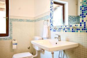 a bathroom with a sink and a toilet at Dunja Residence in Premantura +88 photos
