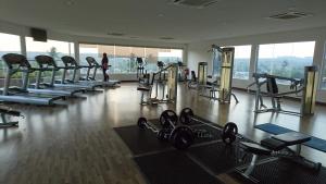 a gym with a bunch of treadmills and machines at Cozy Swiss Garden Beach Resort Residence in Kampung Sungai Karang