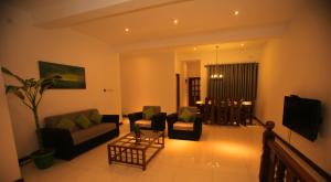 - un salon avec deux canapés et une télévision dans l'établissement Kandyan Fo Rest, à Kandy