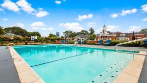 a large swimming pool in front of a building at Best Western Lakewood- Historic Landmark in Lakewood