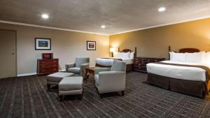 a hotel room with two beds and chairs at Best Western Lakewood- Historic Landmark in Lakewood +18 photos