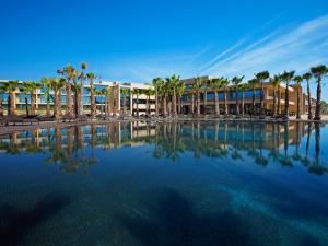 a resort with palm trees and a swimming pool at NAU Sao Rafael Atlantico in Albufeira