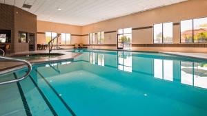 a large swimming pool with blue water in a building at Best Western Elko Inn in Elko