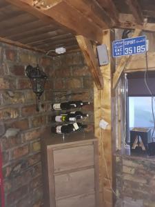 a room with a wall with a bunch of wine bottles at Apartments Artic in Jahorina
