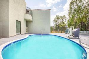 a swimming pool in the backyard of a house at Days Inn by Wyndham Banning Casino/Outlet Mall in Banning