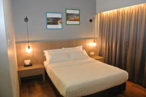 A bed or beds in a room at Riverside Boutique Hotel
