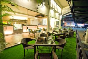 a restaurant with tables and chairs on a patio at Riverside Boutique Hotel in Kuantan