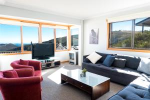 a living room with a couch and a tv at Lawlers 19 in Mount Hotham
