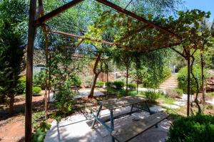 a picnic table and a bench in a garden at Tur Sinai Organic Farm Resort in Jerusalem