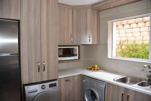 a kitchen with a dishwasher sink and a microwave at 3 Oaklands on the Knoll in Knysna