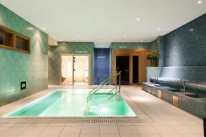 a large swimming pool in a building with at ProfilHotels Opera in Gothenburg