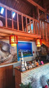 a room with a tv and a picture on a wall at Jinsha Cultural Village in Nangan