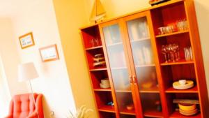 a wooden cabinet with glass doors in a room at Apartamento Somo completo 200m de la playa para 5 personas maximo in Somo +17 photos