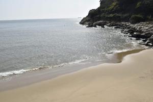 a beach next to the ocean on a cloudy day at Jinsha Cultural Village in Nangan