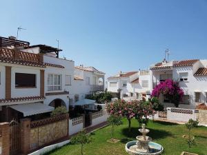 a group of houses with a fountain in a yard at B&B Nerja in Nerja