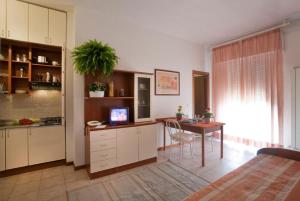 a kitchen with a table and a dining room at Residence Auriga in Rimini