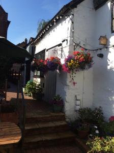 a white building with flowerpots on the side of it at The Talbot Inn in Much Wenlock