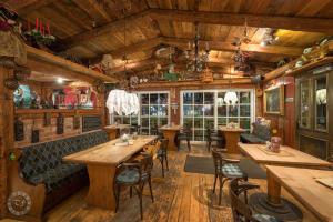 a restaurant with wooden floors and tables and chairs at Hotel - Die kleine Zauberwelt in Braunlage