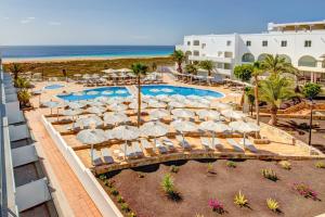 an aerial view of a resort with a pool and umbrellas at SBH Maxorata Resort in Morro del Jable