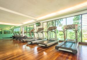 a row of treadmills in a gym with wood floors at RPGC Garden Hotel in Ipoh