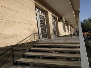 a building with stairs in front of a building at WHITE HOTEL & HOSTEL in Bishkek