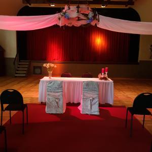 a table in a room with a red curtain at Landgasthof Pension Schützenhaus in Dürrhennersdorf