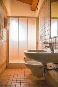 a bathroom with a sink and a toilet at Carlo's Hotel in Castagneto Carducci