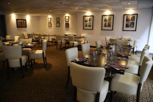 a dining room filled with tables and chairs at Inn On The Prom At The Fernlea Hotel in Lytham St Annes