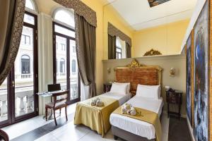 Кровать или кровати в номере Hotel Art Resort Galleria Umberto