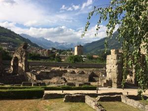 an ancient amphitheater with mountains in the background at Al Teatro Romano - CIR 0343 in Aosta