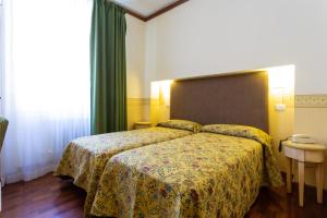 Letto o letti in una camera di Albergo Il Cacciatore