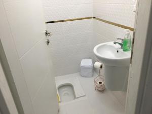 a small bathroom with a sink and a toilet at Trabzon Sea Pearl in Trabzon +61 photos