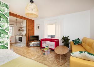 a living room with a couch and a tv at Cute apartment, next to old town, with free parking in Tallinn