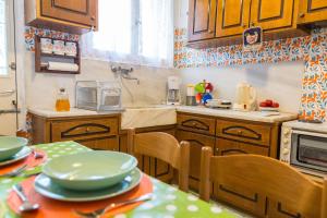 a kitchen with wooden cabinets and a table with plates on it at Anna's beautiful house in Leonidion +14 photos