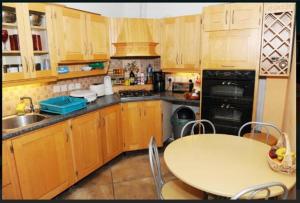 a kitchen with a table and a sink and a stove at The Hideout ! in Dublin