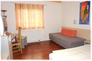 a bedroom with a bed and a desk and a window at Brau Art Hotel in Neckarsulm +3 photos