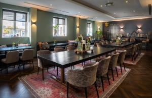 a row of tables and chairs in a restaurant at Van der Valk Hotel Hildesheim in Hildesheim