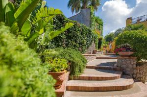 a row of stairs with plants and flowers at Hotel Villa Ceselle in Anacapri