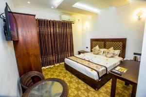 a bedroom with a bed and a desk and a television at Euro Star Hotel in Katunayaka +88 photos