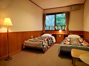 Postel nebo postele na pokoji v ubytování Okushiga Lodge Yama no Manimani