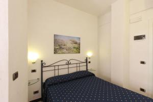 a bedroom with a bed in a white room at Albergo Al Carugio in Monterosso al Mare