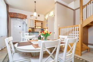 a kitchen and dining room with a table and chairs at Elegant Apartments in Krakow