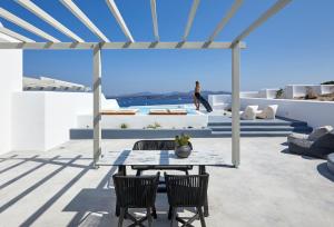 a woman walking on the roof of a house at Phos The Boutique in Akrotiri
