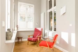 a living room with two chairs and a table at OSTKÜSTE - Nadler Hof Design Apartments in Ahlbeck