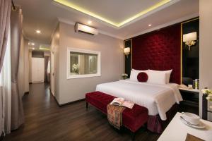 A bed or beds in a room at Hanoi L'Heritage Centre Hotel & Spa