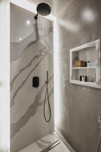 a shower in a bathroom with a wall mural at Phos The Boutique in Akrotiri
