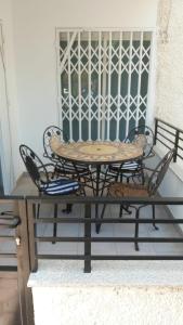 a table and chairs sitting on a porch at Jazmines in Santiago de la Ribera