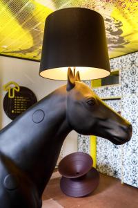 a lamp with a statue of a horse on a table at Youth Hostel Würzburg in Würzburg