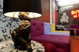 a statue of a bear sitting on a table with a lamp at Youth Hostel Würzburg in Würzburg
